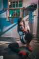 A woman sitting on the ground in a room.