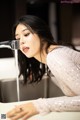 A woman is washing her hands under a faucet.