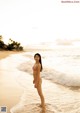 A woman in a bikini standing in the ocean.