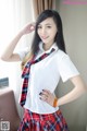 A woman in a school uniform posing for a picture.