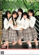 A group of young women in school uniforms posing for a magazine cover.