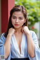 A woman in a blue and white kimono posing for a picture.