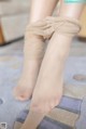 A close up of a woman's legs tied up with a bandage.